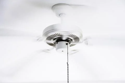 White ceiling electrical fan in motion Stock Photos
