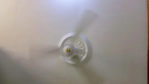 White ceiling fan rotating on a white plasterboard ceiling. Stock Footage 314084788