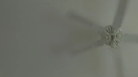 White ceiling fan spinning indoor handheld static shot Stock-Footage 343373151