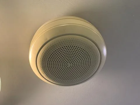 White ceiling speaker with white ceiling, commonly used to play music Stock Photos