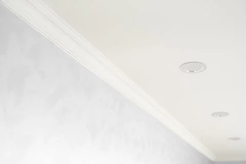 White ceiling with a white plinth in a room with gray painted walls. Decoration Stock Photos