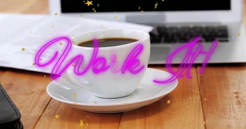 White ceramic coffee cup resting on wooden desk while neon Work It! script Stock Footage 307450533