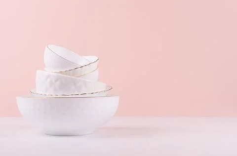 White ceramic crockery stack with golden bezel, different texture on white wo Stock Photos