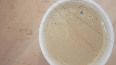 White ceramic cup being presented in closeup view, showing frothy coffee bubbles Stock Footage 307445530