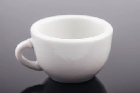 White ceramic Cup on a black background closeup Stock Photos