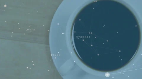 White ceramic cup brimming with dark coffee while glowing network nodes floating Stock Footage 307444192