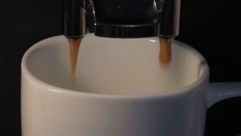 White ceramic cup filled with coffee in a coffee machine Stock Footage 94578335