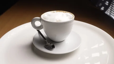 White ceramic cup of fresh cappuccino with milk foam 스톡 동영상 335387498