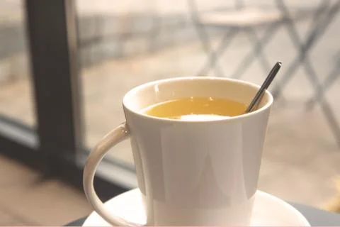 White ceramic cup with ginger tea on a table in a cafe Stock Photos