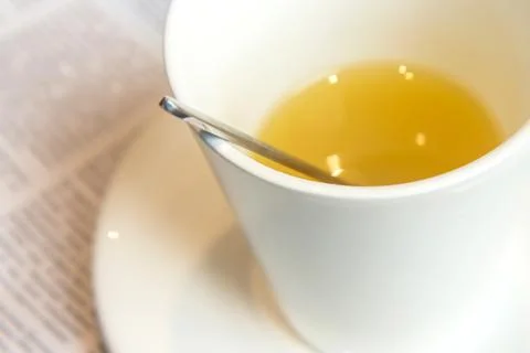 White ceramic cup with ginger tea on a table in a cafe Stock Photos
