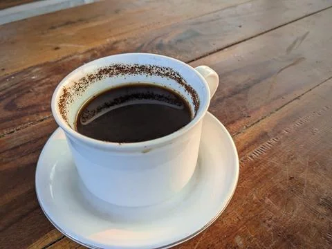 White ceramic cup of hot black coffee on wooden table, cafe, copy space Stock Photos