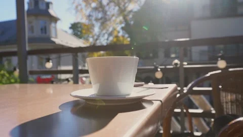 White ceramic cup of hot coffee or tea with steam standing on table Stock Footage 219252787