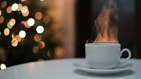 White ceramic cup with hot drink of coffee tea cocoa on saucer stands on table Stock Footage 223538976