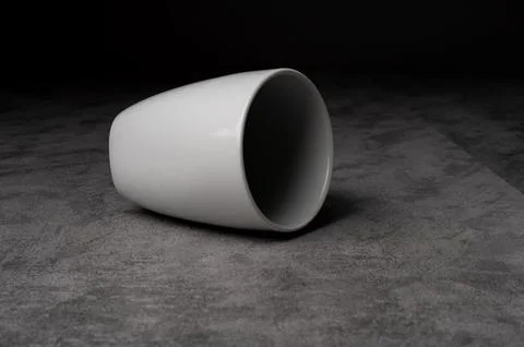 White Ceramic Cup on Textured Surface Stock Photos