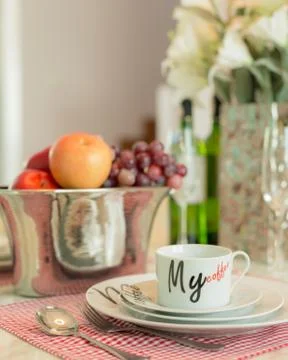 White ceramic dish cup set on dining table set decorate with fruits and flowers Stock Photos