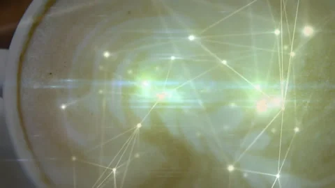 White ceramic latte cup showing foam swirl overlaying glowing network nodes on Stock Footage 307446030