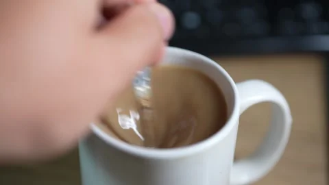 A white ceramic mug filled with hot coffee and milk. Video stock 347644838