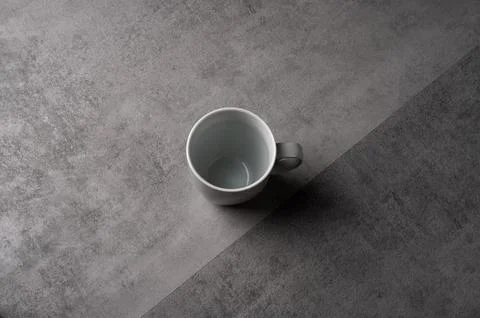 White Ceramic Mug on Grey Table with Dark Background Stock Photos