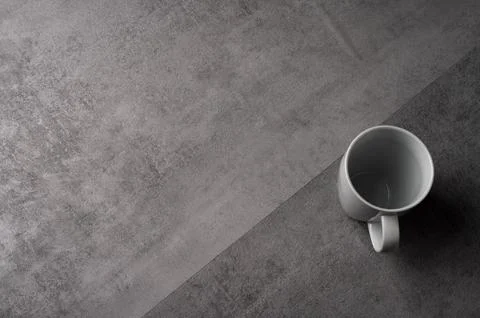 White Ceramic Mug on Grey Table with Dark Background Foto stock