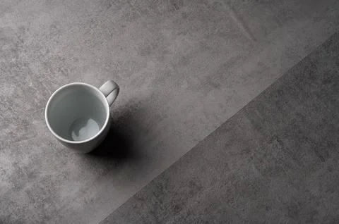 White Ceramic Mug on Grey Table with Dark Background Stock Photos