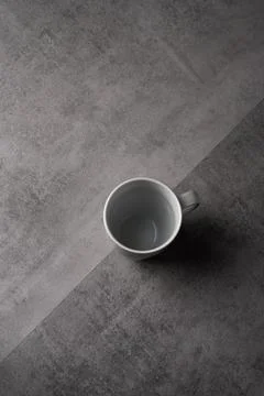 White Ceramic Mug on Grey Table with Dark Background Stock Photos