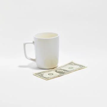 White Ceramic Mug with US Dollar Bill on Clean Background Stock Photos