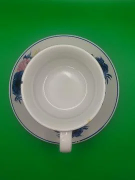 White ceramic object on vibrant green background top view Stock Photos