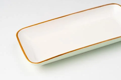 White ceramic rectangular serving tray with an orange outline 스톡 사진