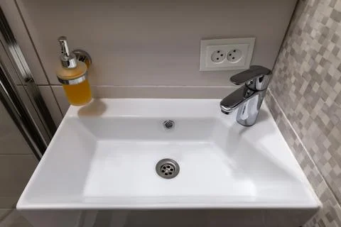 White ceramic rectangular washbasin with corner arrangement single handle mix Photos