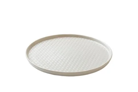 White ceramic round plate isolated over white background. perspective view Stock Photos