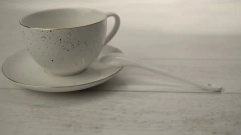 White Ceramic Tea Set with Spoon on Light Wood Stock Footage 268111721