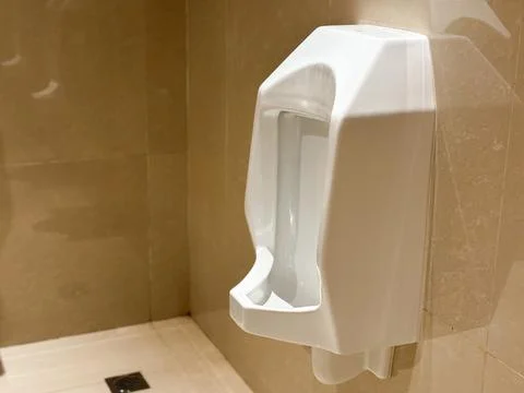 White Ceramic Urinal Mounted Beige Marble Wall Luxury Public Restroom Interior Stock Photos