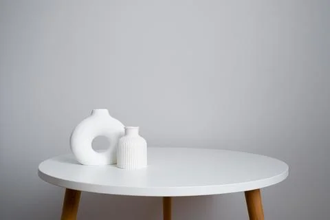 White ceramic vases on a round table. Minimalism at home Stock Photos