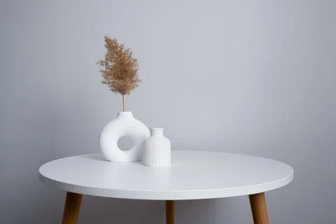 White ceramic vases on a round table. Minimalism at home Stock Photos