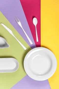 White ceramic ware on a multi-colored background.. Stock Photos