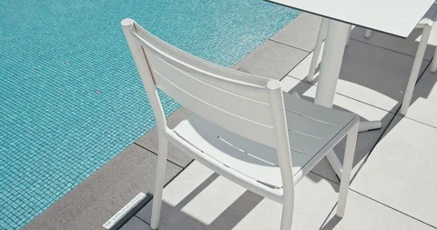 White chair and table is next to the blue water pool. Vacation concept. Stock Footage 120430202
