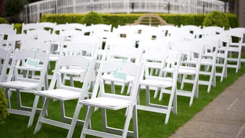 White chairs lined up for a wedding ceremony Stock Footage 278047301