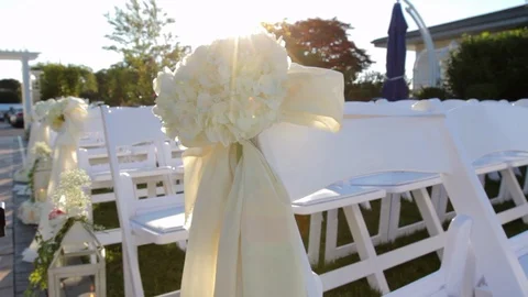 White chairs set in rows with white bows and flowers 動画素材 92076027