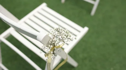 White chairs for a wedding ceremony with decor Stock Footage 271203323