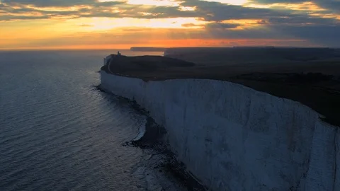 White chalk cliffs and Beachy Head Lighthouse. Eastbourne, East Sussex, England Stock Footage 88542563