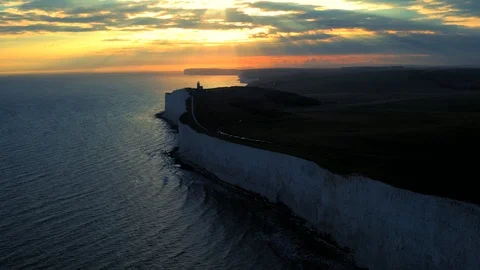 White chalk cliffs and Beachy Head Lighthouse. Eastbourne, East Sussex, England Stock Footage 88542653