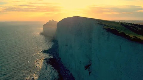 White chalk cliffs and Beachy Head Lighthouse. Eastbourne, East Sussex, England Stock Footage 88591751