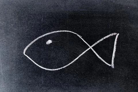 White chalk drawing in fish shape on black board background Stock Photos