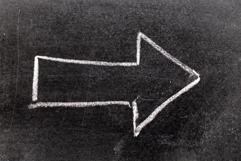 White chalk hand drawing in arrow shape on black board background Stock Photos