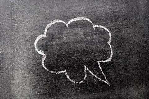 White chalk hand drawing in cloud bubble speech shape with blank space on bla Stock Photos