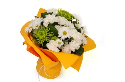 White chamomile and carnation in a paper bouquet tied ribbon on a white bac.. Stock Photos