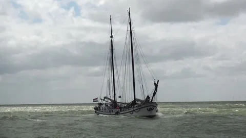 White charter ship in front of the harbor with lowered sails  Stock Footage 150689079
