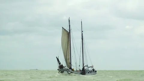 White chartership dropping his mainsail Stock Footage 85023090