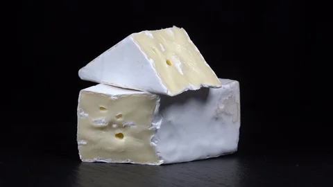 White cheese Brie on black background. Rotates fresh cheese Brie. Close up Stock Footage 94490997