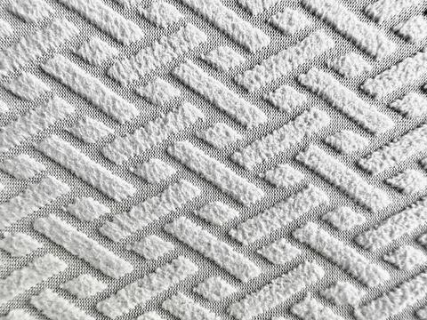 White chenille geometric fabric texture displays embossed chevron pattern on  Foto stock